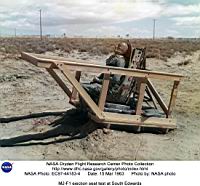 Le gag du test de l’&eacute;jection z&eacute;ro-z&eacute;ro, une premi&egrave;re : le mannequin figurant Milt Thompson battra longtemps les bras dans les airs avant de retomber, le parachute de son si&egrave;ge ne s’&eacute;tant pas ouvert ! Remarquez la rusticicit&eacute; du b&acirc;ti de test !